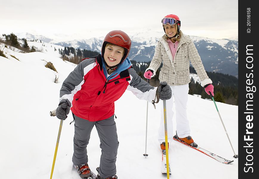 Young Mother And Son On Ski Vacation smiling