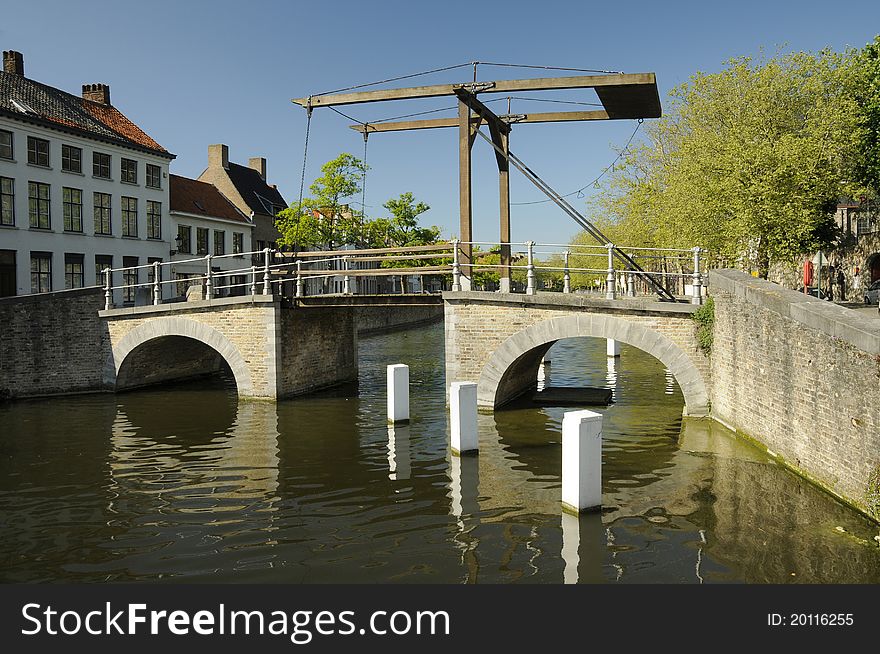 A Lifting Bridge Over A River In Brugge In Belgium