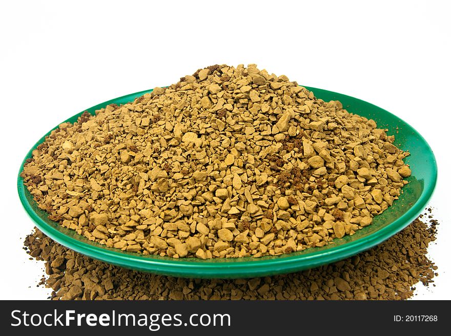 Coffee granules in a green bowl on white background