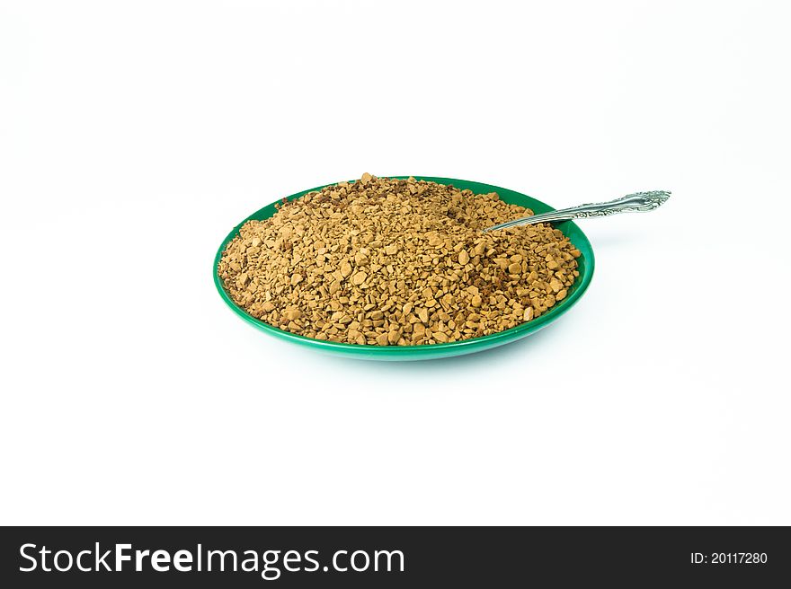 Coffee granules in a green bowl on white background