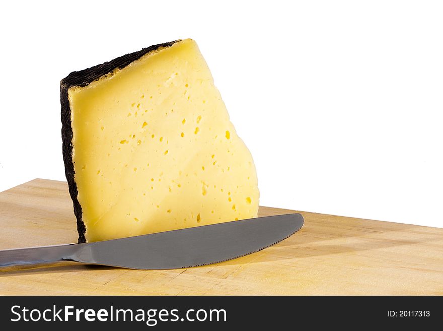 Piece of cheese on cutting board, food