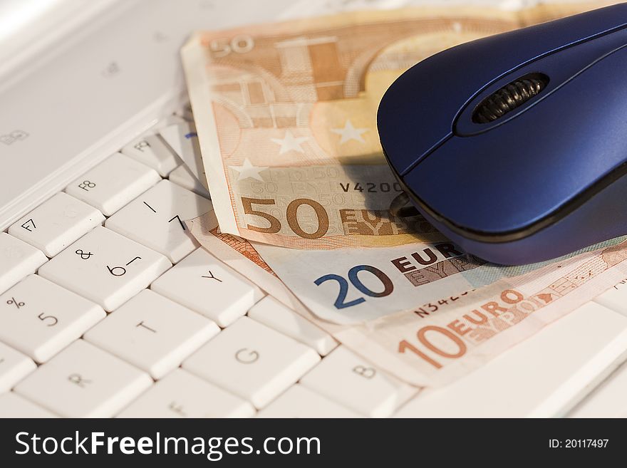 Computer mouse on the keyboard with money to buy online. Computer mouse on the keyboard with money to buy online