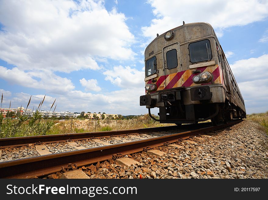 Passenger train in motion and sky with clouds, Portugal