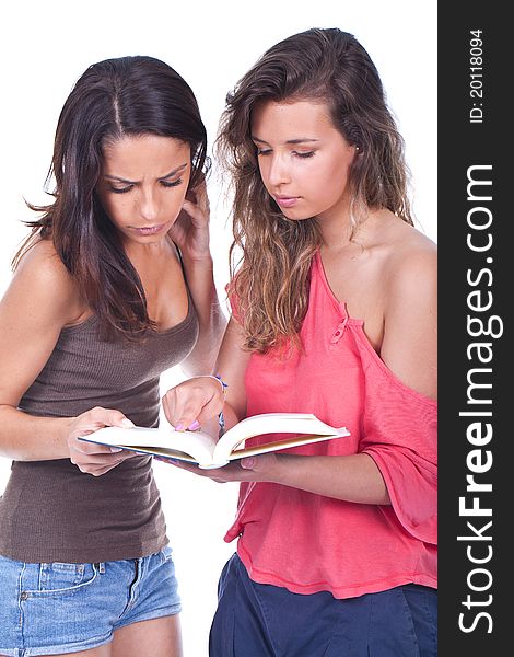 Two beautiful women standing and reading a book. Two beautiful women standing and reading a book