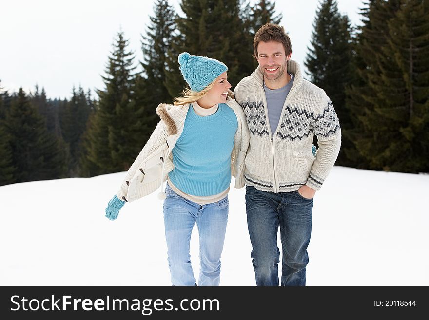 Young Couple In Alpine Snow Scene