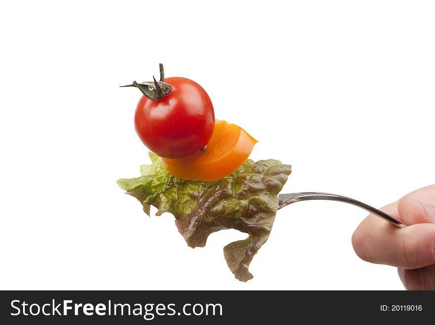 Sandwich of tomato, peppers and lettuce on a fork. Sandwich of tomato, peppers and lettuce on a fork.