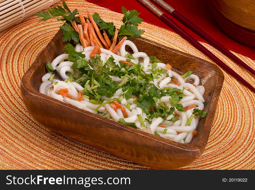Asian noodle soup in a brown wooden bowl. Asian noodle soup in a brown wooden bowl.