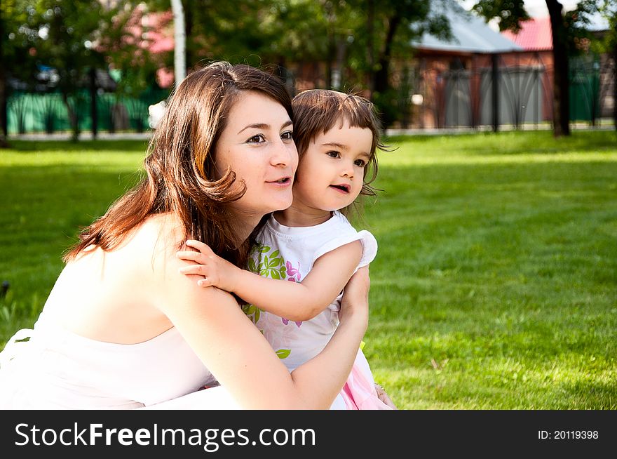 Mum embraces the daughter and together somewhere look