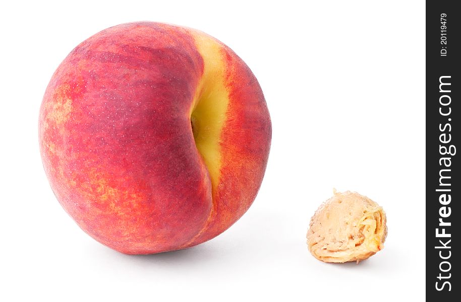 Peach and pit isolated on white background