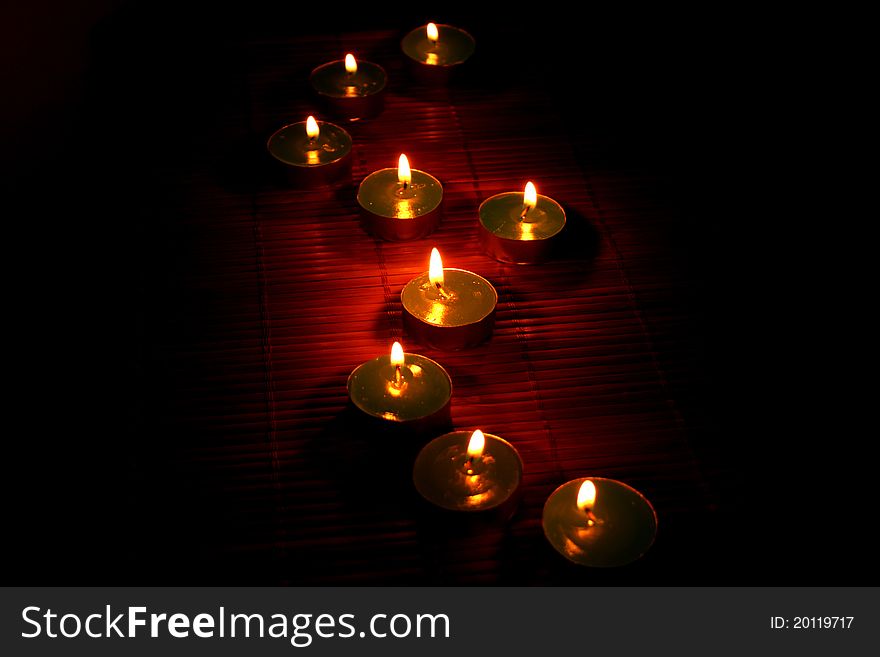 Candles on the bamboo in night.