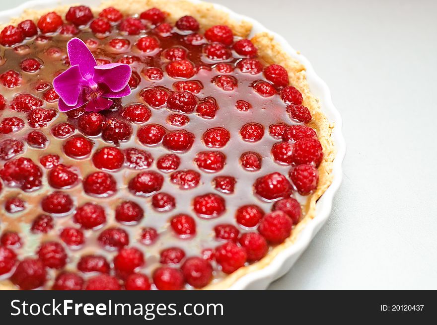 Tart with raspberries and curd in a ceramic tray