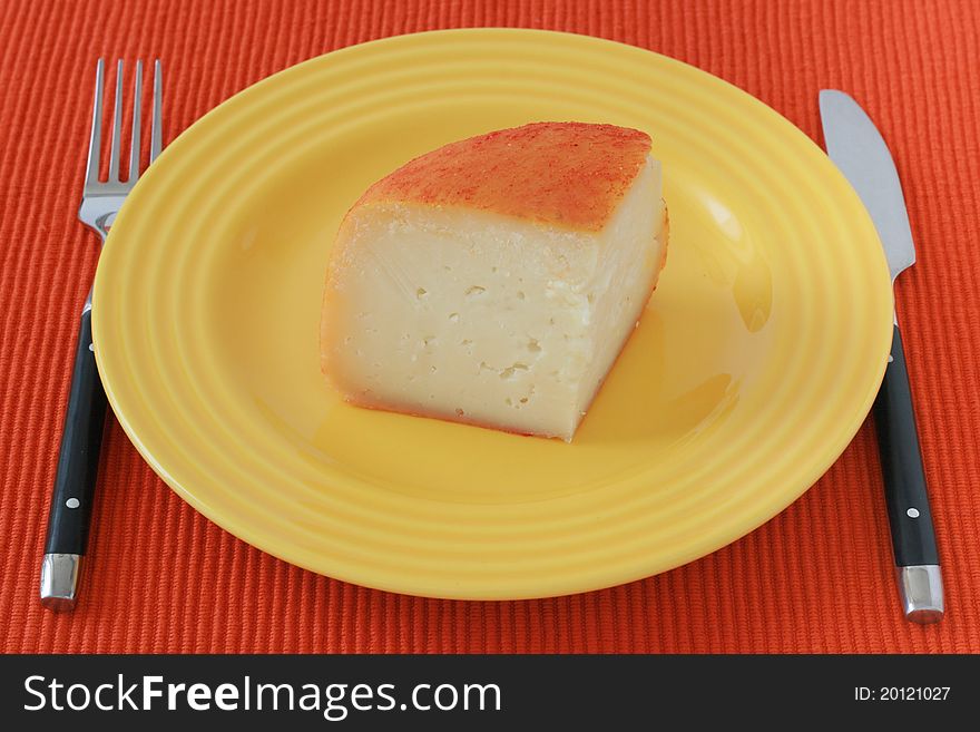 Cheese on an yellow plate. Cheese on an yellow plate