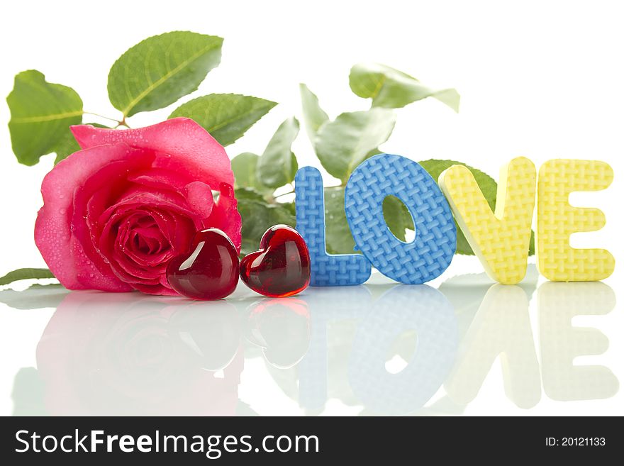 Beautiful red rose, two red hearts and a number of the text of the letters love. Isolated on white background. Beautiful red rose, two red hearts and a number of the text of the letters love. Isolated on white background