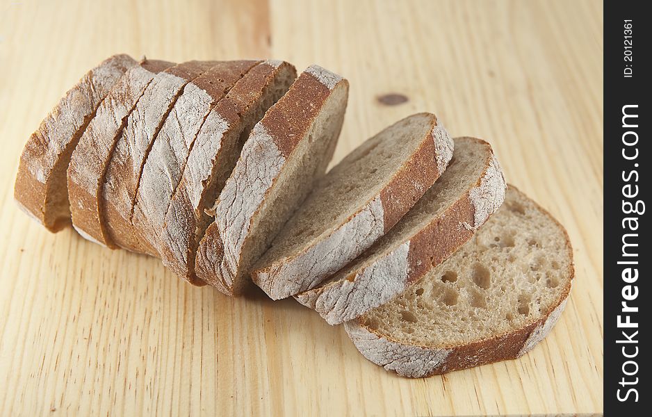 Fresh bread sliced on the wooden board