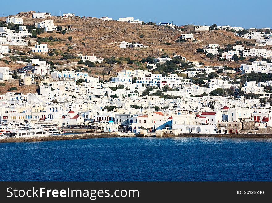 The coastline of greek island of mykonos with all the white washed houses clinging to the water. The coastline of greek island of mykonos with all the white washed houses clinging to the water