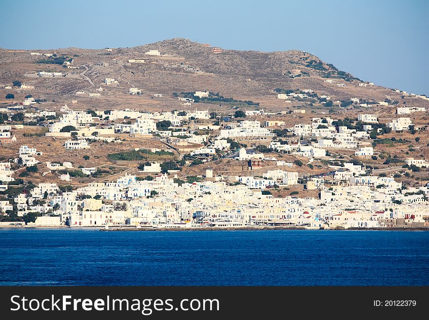 The coastline of greek island of mykonos with all the white washed houses clinging to the water. The coastline of greek island of mykonos with all the white washed houses clinging to the water