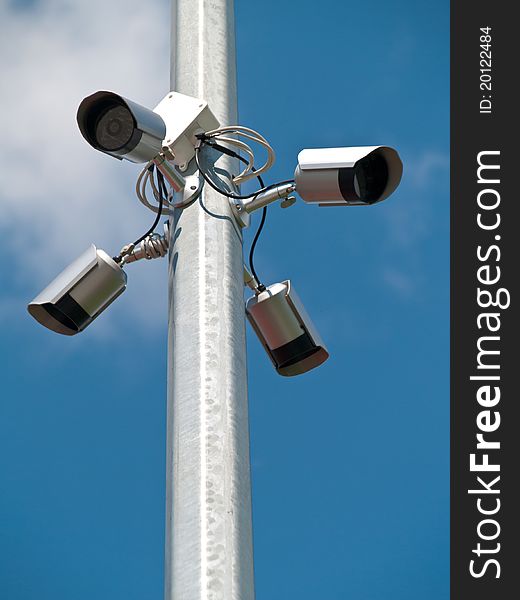 Four surveillance cameras positioned on the pole lanterns schoolyard. Four surveillance cameras positioned on the pole lanterns schoolyard