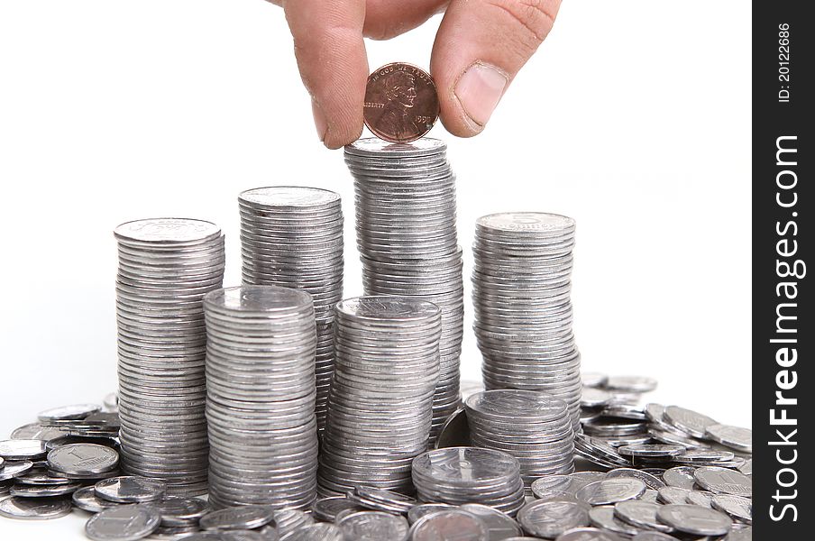 Hand put coin to money staircase. Isolated on white background