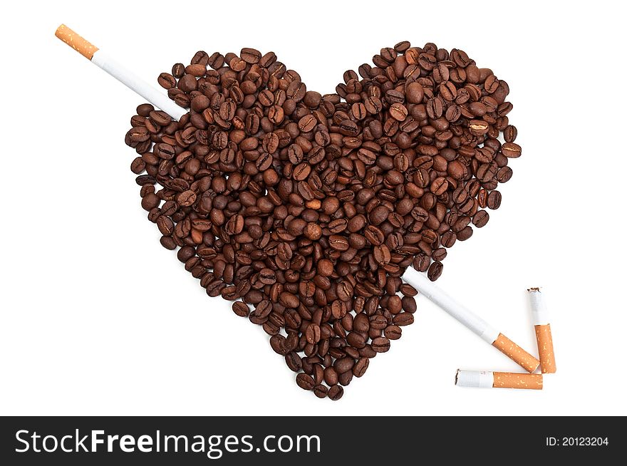 Roasted coffee beans in the shape of the heart with cigarettes isolated on a white background