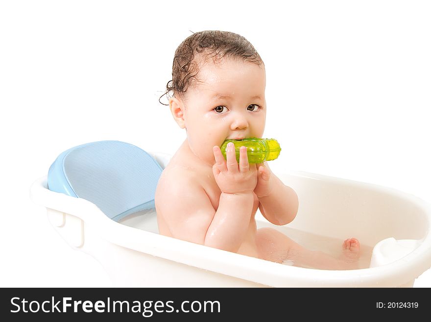 Baby playing with a toy in a bathtub. Baby playing with a toy in a bathtub.