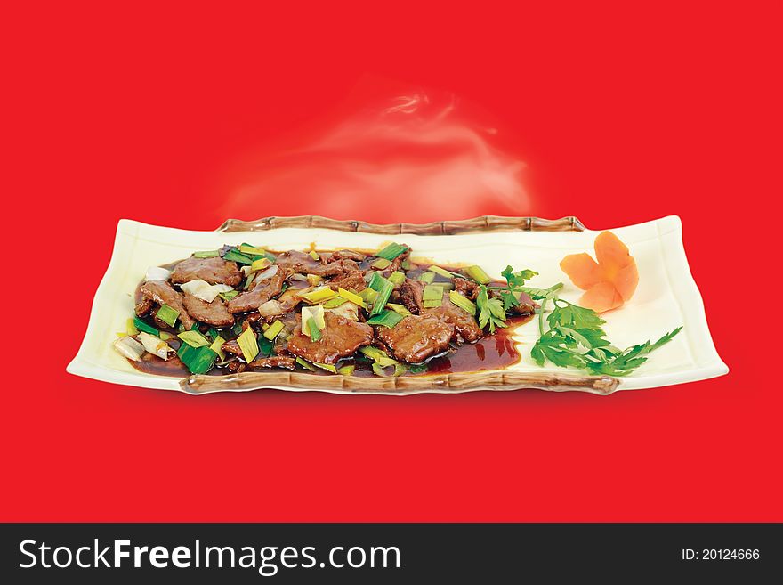 Chinese cuisine. Beef with Spring Onions on red background. Chinese cuisine. Beef with Spring Onions on red background.