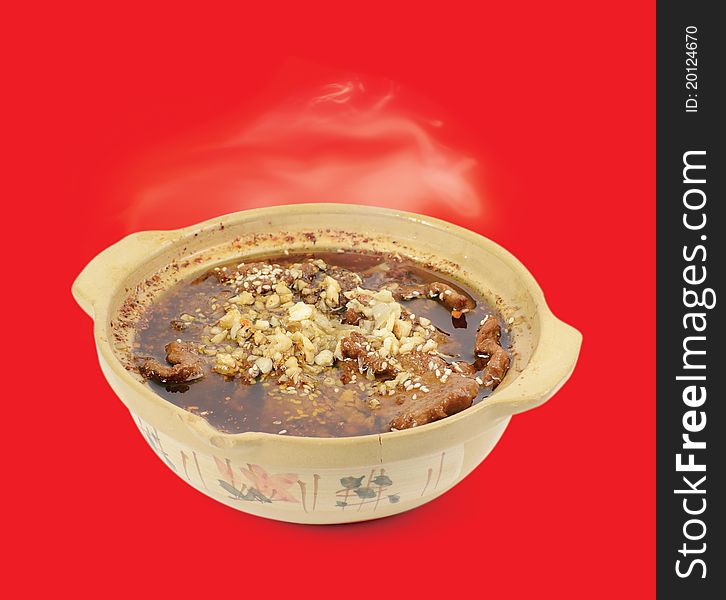 Chinese cuisine. Beef hot pot on a red background. Chinese cuisine. Beef hot pot on a red background.