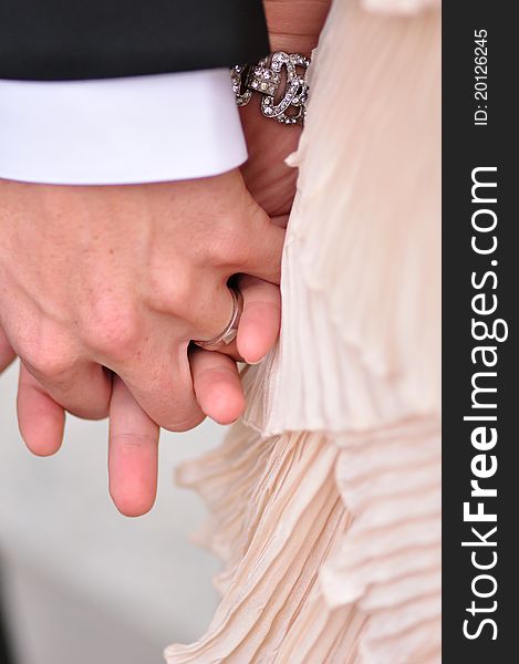 Hands of the Bride and Groom with Wedding Ring and Diamond Bracelet