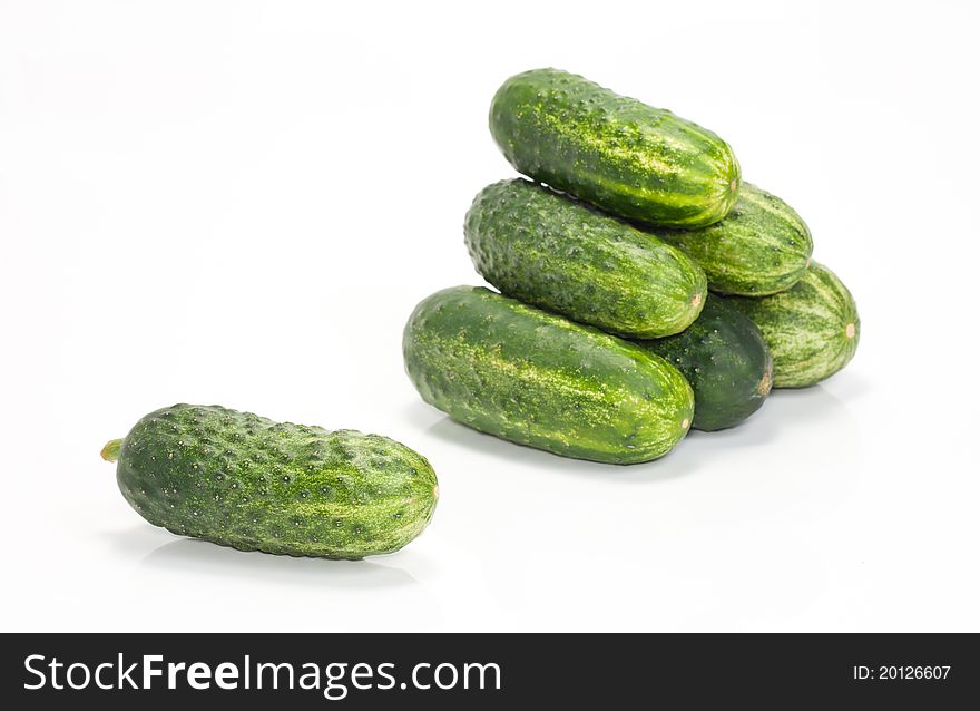 One and a few green cucumbers isolated on a white background