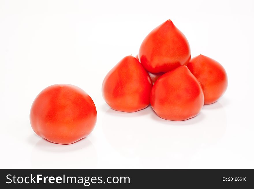 One and a few red tomatoes isolated on a white background