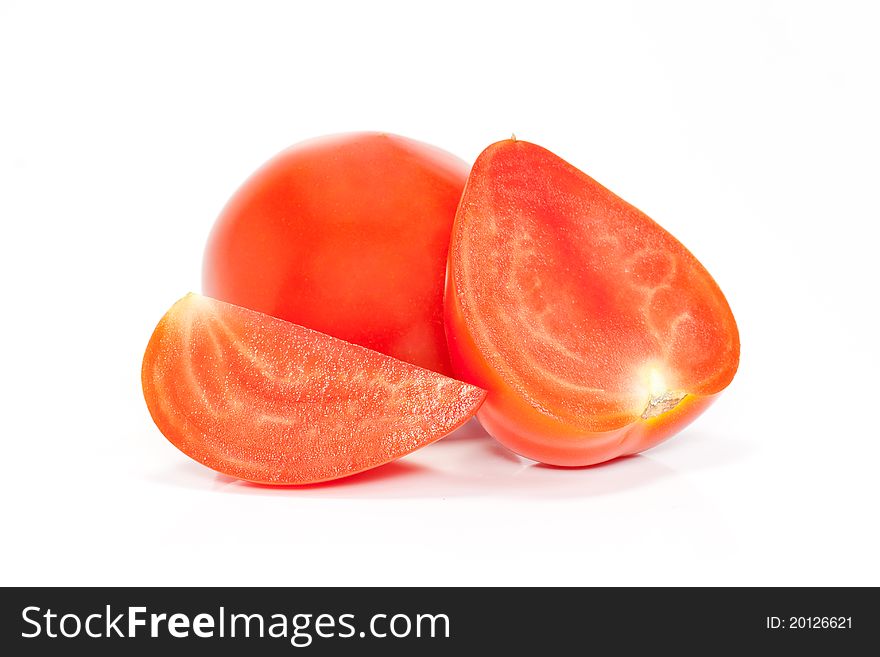 Cut and whole red tomatoes isolated on a white background