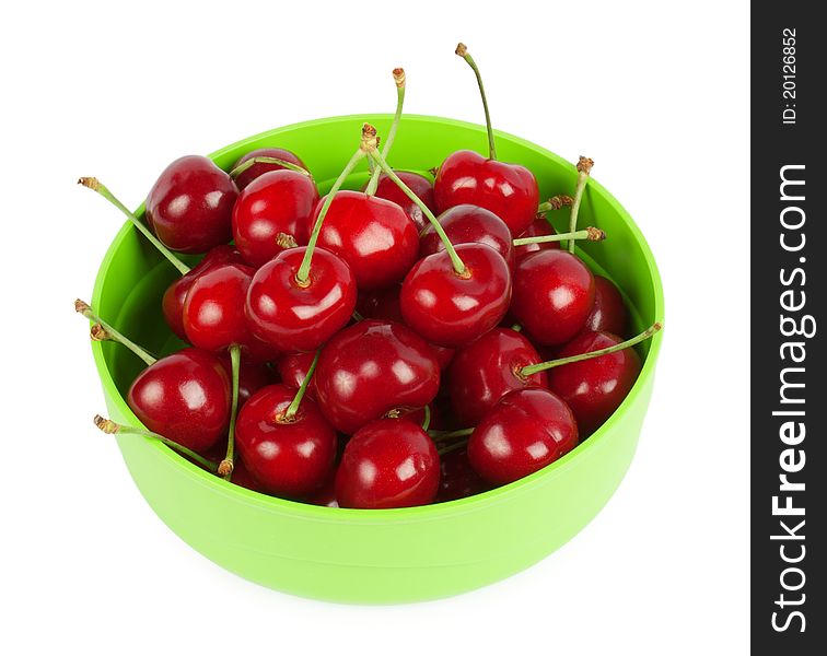 Red cherries on a plate isolated on white