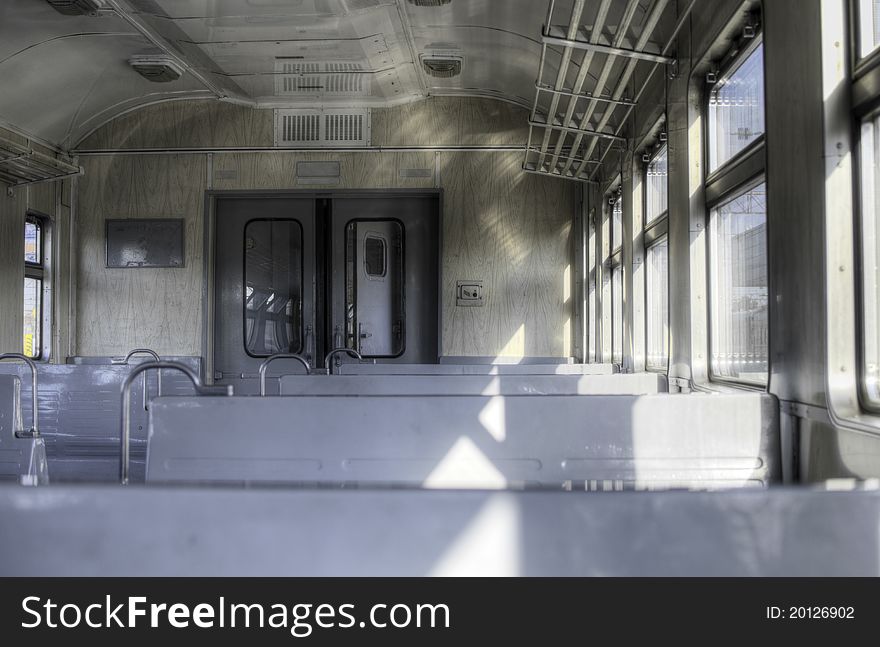 Empty interior of the passenger train. High dynamic range photo. Focused at the door. Empty interior of the passenger train. High dynamic range photo. Focused at the door.