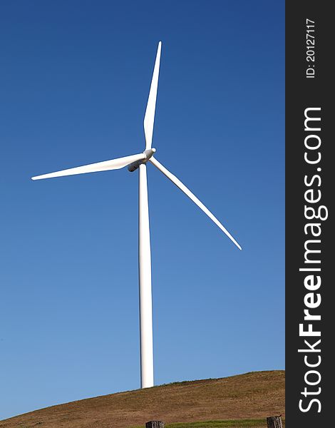 A wind turbine on top of a hill in Washington state. A wind turbine on top of a hill in Washington state.