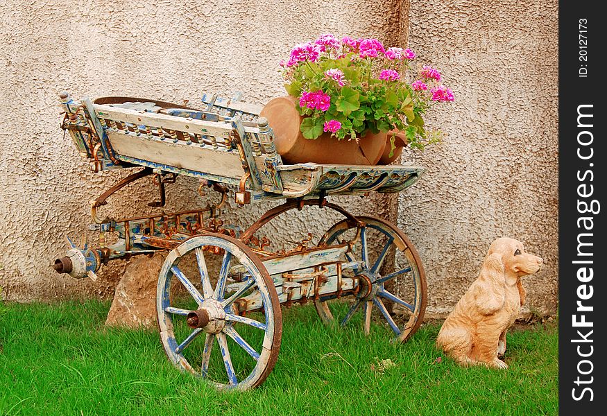 Flowers in flowerpot on old cart