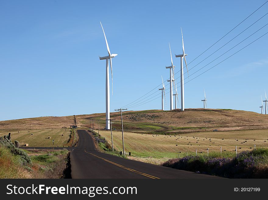 Wind turbines along the hills in rural Washington state. Wind turbines along the hills in rural Washington state.