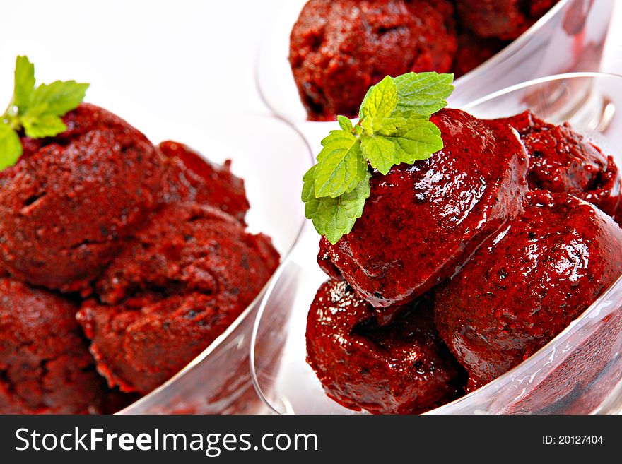 Ice cream made of forest fruits, decorated with mint, isolated on white