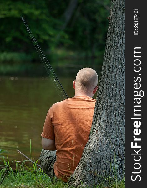 Young man relaxing and fishing on a lake in Virginia. Young man relaxing and fishing on a lake in Virginia.