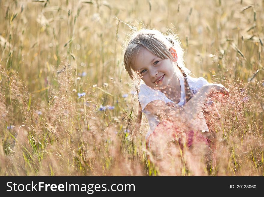 Blond hair girl in a meadow, surraunded by grain. Blond hair girl in a meadow, surraunded by grain.