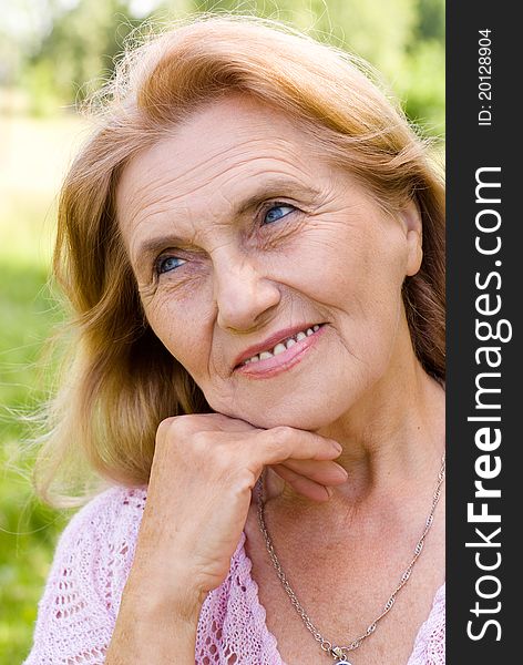 Portrait of a nice aged woman at nature. Portrait of a nice aged woman at nature