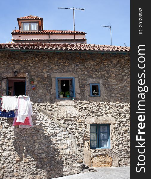 White laundry hanging to dry in a stone house