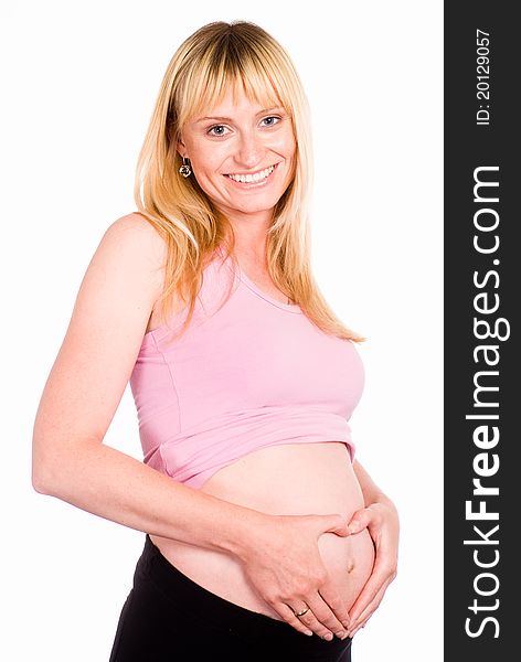 Beautiful pregnant woman standing on a white. Beautiful pregnant woman standing on a white