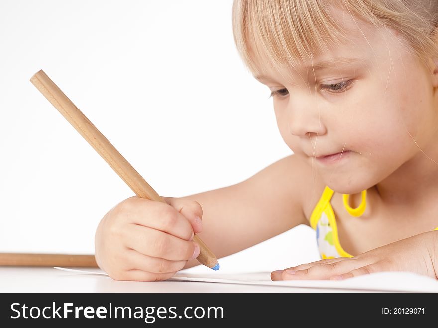 Little girl draws on a white background