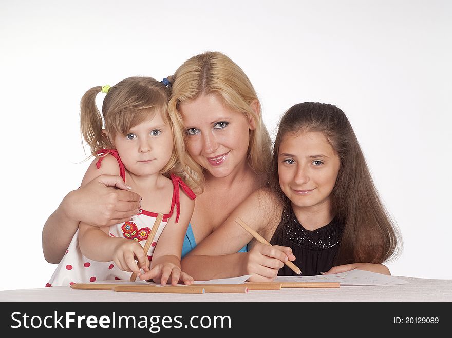 Portrait of a three girls drawing on a white. Portrait of a three girls drawing on a white