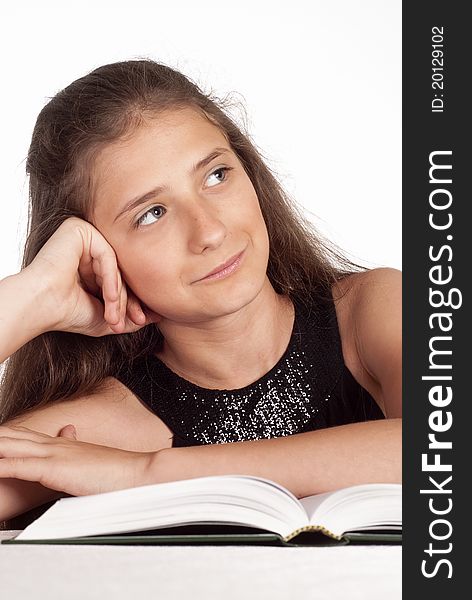 Portrait of a cute young girl reading a book. Portrait of a cute young girl reading a book