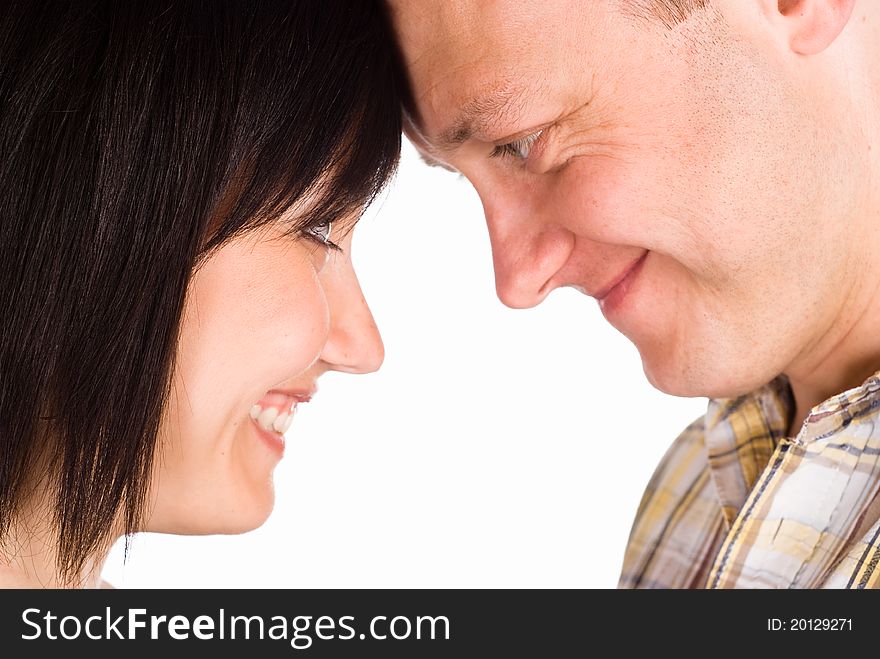 Happy cute couple posing on a white. Happy cute couple posing on a white