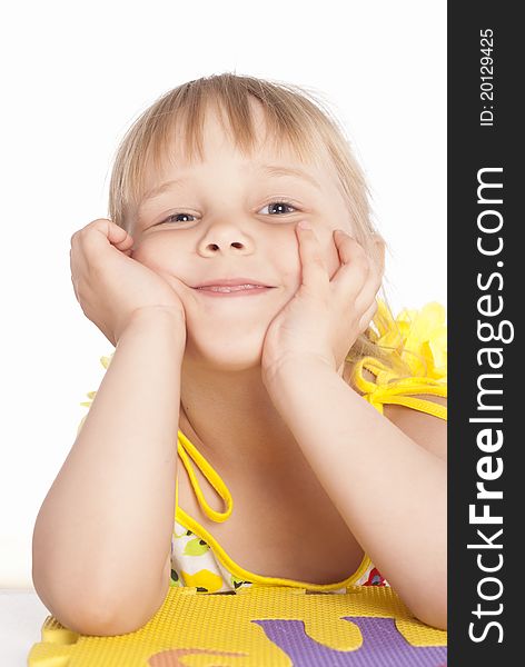 Little girl smiles on a white background