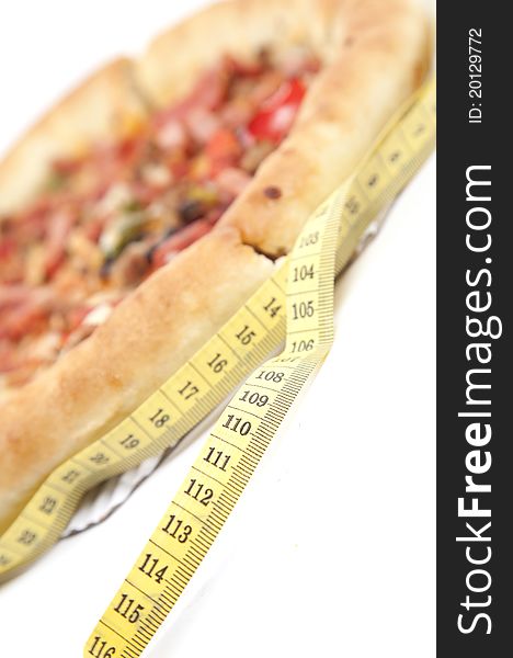 Close up of pizza with measurement tape isolated over white. Close up of pizza with measurement tape isolated over white