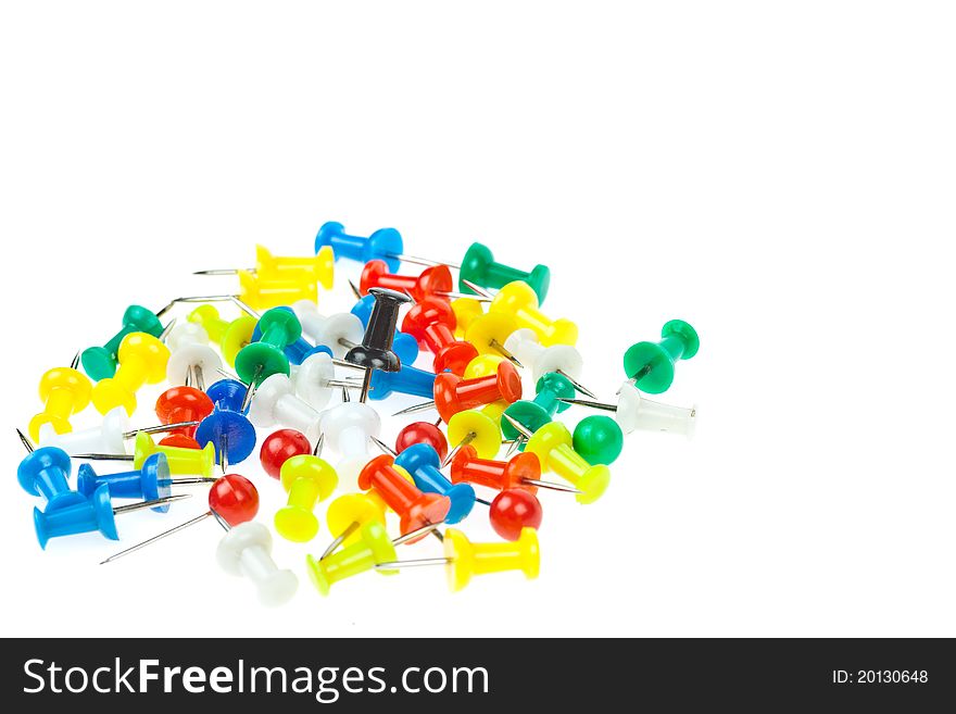 Isolated colorful pushpins focus at black