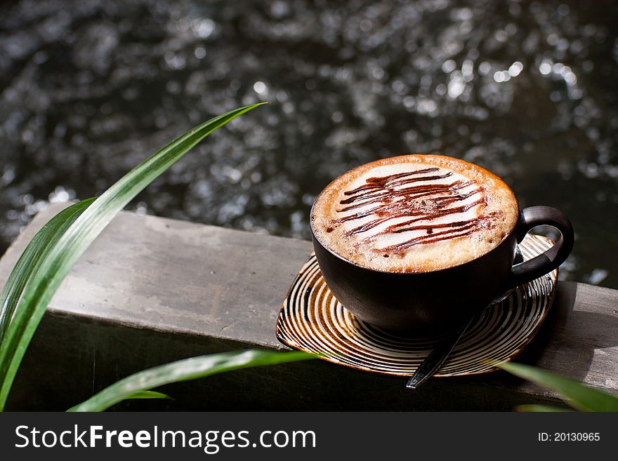 Cup of cappuccino in the garden