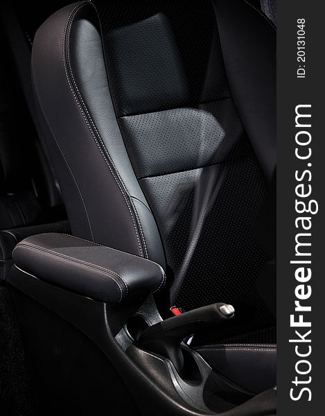 Part and detail of sedan interior setting and decoration, which is diver seat and arm rester, shown as functional design of car and luxury configuration.